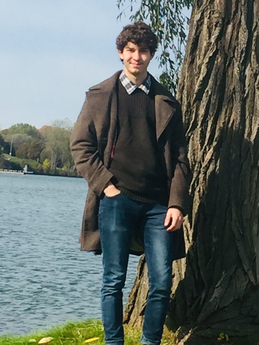 Mat Benson standing beside a willow tree on the shore of a lake in Wisconsin
